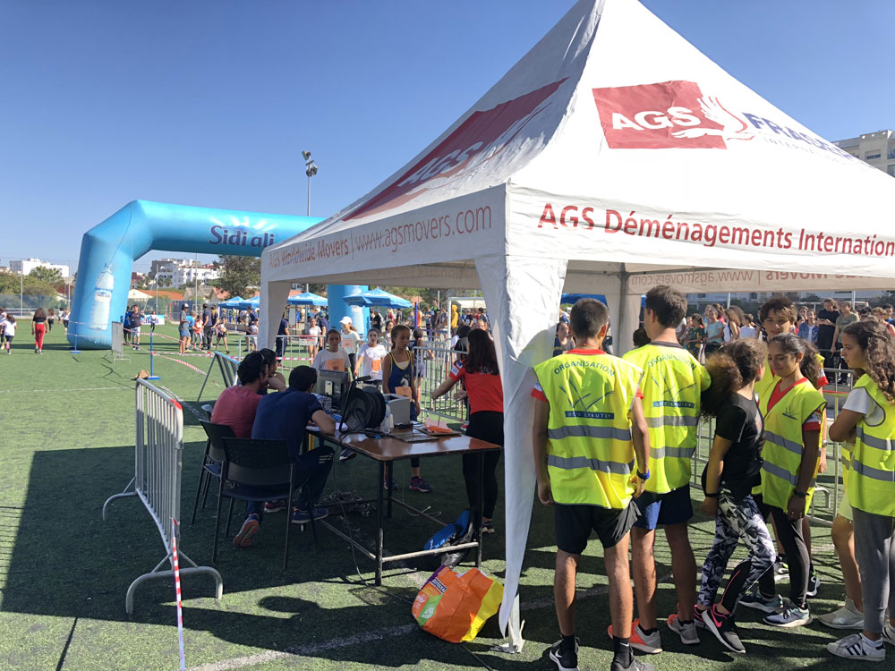 AGS Movers branded tent at a sporting event.