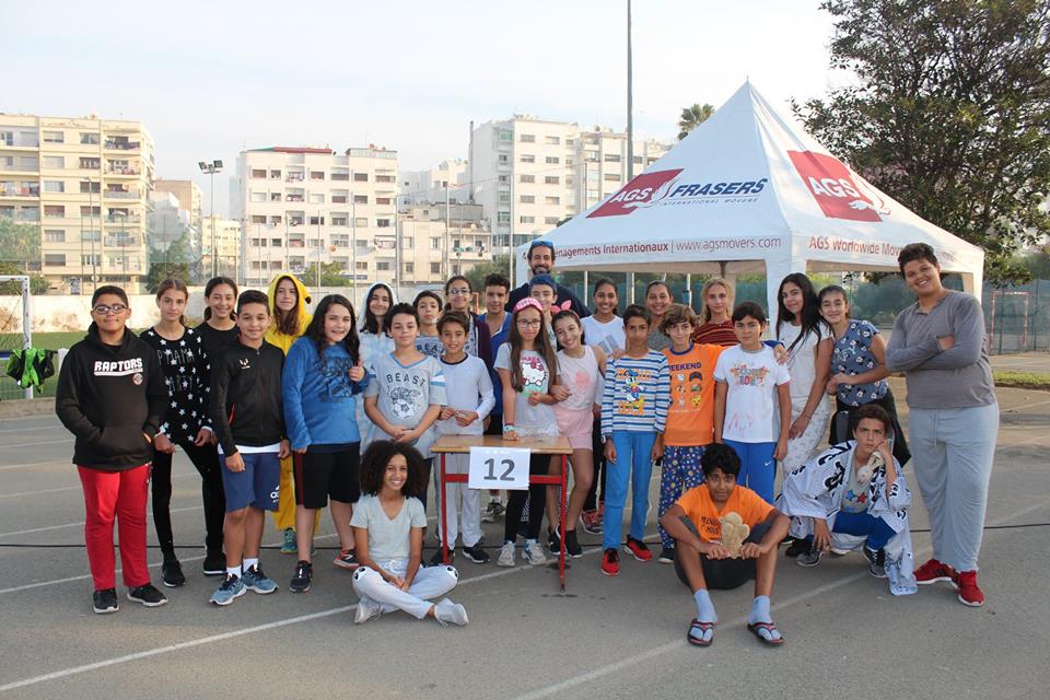 School kids posing by an AGS Movers tent in Casablanca, Morocco.