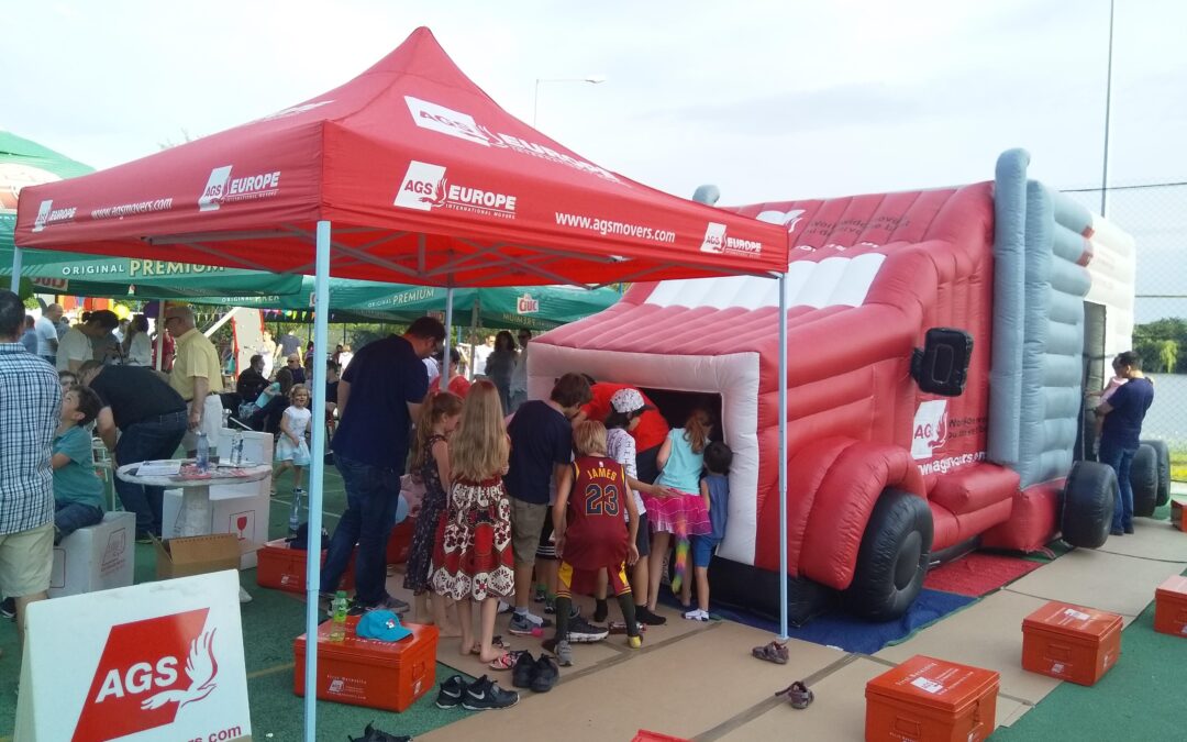 AGS Movers booth and jumping truck.